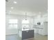 Modern kitchen featuring a center island, white cabinets, and contemporary lighting at 723 W 113Th Ave, Tampa, FL 33612
