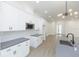 Bright kitchen features a center island, white cabinets, light gray countertops, and stainless steel microwave at 723 W 113Th Ave, Tampa, FL 33612