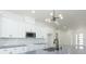 Bright kitchen features white cabinets, light gray countertops, stainless steel microwave, and a modern light fixture at 723 W 113Th Ave, Tampa, FL 33612