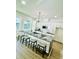 Bright open kitchen with large island, modern light fixture, and sleek white cabinetry at 723 W 113Th Ave, Tampa, FL 33612