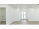 Bright living room features a modern door, neutral walls, and wood-look floors at 723 W 113Th Ave, Tampa, FL 33612