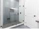 Modern shower stall with glass door, gray tile and matte black hardware at 723 W 113Th Ave, Tampa, FL 33612