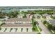 Aerial view of a townhouse community with garages, landscaping and a nearby lake at 7325 Parkshore Dr, Apollo Beach, FL 33572