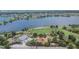 Aerial view of a community park with a playground, splash pad, and lake at 7325 Parkshore Dr, Apollo Beach, FL 33572