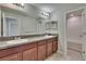 Bathroom featuring a double vanity, granite countertop and a bathtub at 7325 Parkshore Dr, Apollo Beach, FL 33572