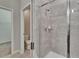 Bathroom featuring tiled glass shower, with gray ceramic tile, and a separate toilet at 7325 Parkshore Dr, Apollo Beach, FL 33572