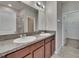 Bathroom featuring dual sinks, granite countertops, and wood cabinets at 7325 Parkshore Dr, Apollo Beach, FL 33572