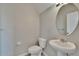 Powder room featuring a pedestal sink, and round mirror creating a simple look at 7325 Parkshore Dr, Apollo Beach, FL 33572