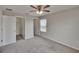 Bedroom with carpet, fan, and a closet, offering a comfortable and functional space at 7325 Parkshore Dr, Apollo Beach, FL 33572