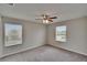 Spacious carpeted bedroom featuring windows for natural light and a ceiling fan at 7325 Parkshore Dr, Apollo Beach, FL 33572