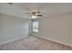 Cozy bedroom with a ceiling fan, soft carpet, and sunlit window at 7325 Parkshore Dr, Apollo Beach, FL 33572