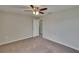 Bedroom featuring soft carpet, ceiling fan, and adjacent door to hallway at 7325 Parkshore Dr, Apollo Beach, FL 33572