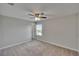 Bedroom includes carpet, fan, window, and a door leading out of the room at 7325 Parkshore Dr, Apollo Beach, FL 33572