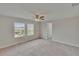 Bedroom with a ceiling fan, carpet, and windows providing natural light at 7325 Parkshore Dr, Apollo Beach, FL 33572