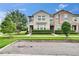 Charming two-story townhome featuring a well-manicured lawn and lush green hedges at 7325 Parkshore Dr, Apollo Beach, FL 33572