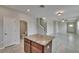 Bright living room with modern ceiling fan, tile floor, and staircase view at 7325 Parkshore Dr, Apollo Beach, FL 33572
