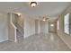 Inviting living room featuring tile flooring and staircase leading upstairs at 7325 Parkshore Dr, Apollo Beach, FL 33572