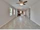 Bright and spacious living room with ceramic tile flooring leading to kitchen at 7325 Parkshore Dr, Apollo Beach, FL 33572