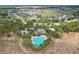 Aerial view of community pool nestled among lush trees within a meticulously designed neighborhood at 810 Hillshire Pl, Spring Hill, FL 34609