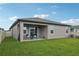Backyard with a covered patio and a well-maintained lawn at 810 Hillshire Pl, Spring Hill, FL 34609