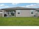 Spacious backyard with a well-manicured lawn and a covered patio at 810 Hillshire Pl, Spring Hill, FL 34609
