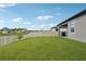 Large backyard with a well-manicured lawn and a white fence at 810 Hillshire Pl, Spring Hill, FL 34609