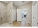 Bright bathroom with a glass-enclosed shower and access to the primary bedroom at 810 Hillshire Pl, Spring Hill, FL 34609