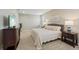 Serene bedroom with plush carpet, a queen size bed and side tables at 810 Hillshire Pl, Spring Hill, FL 34609