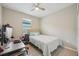 Comfortable bedroom with a ceiling fan and a sunny window at 810 Hillshire Pl, Spring Hill, FL 34609