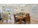 Bright dining room with wood floors and views of the back yard at 810 Hillshire Pl, Spring Hill, FL 34609