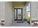 Elegant front door with decorative glass, side window, and beautiful stone accents at 810 Hillshire Pl, Spring Hill, FL 34609