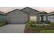 Charming single-story home with a well-manicured lawn and a two-car garage at 810 Hillshire Pl, Spring Hill, FL 34609