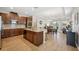 Open kitchen featuring dark wood cabinetry, an island with bar seating, and modern appliances at 810 Hillshire Pl, Spring Hill, FL 34609