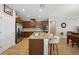 Well-lit kitchen with stainless steel appliances, dark wood cabinets, and a kitchen island at 810 Hillshire Pl, Spring Hill, FL 34609