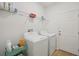 Well-lit laundry room with modern washer and dryer at 810 Hillshire Pl, Spring Hill, FL 34609