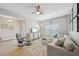Comfortable living room with neutral decor, a ceiling fan, and a large window at 810 Hillshire Pl, Spring Hill, FL 34609