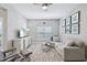 Bright living room with a large sectional sofa, accent chair, and wall-mounted television at 810 Hillshire Pl, Spring Hill, FL 34609