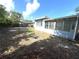 Spacious backyard featuring a sunroom extension and partial fencing at 814 19Th Sw St, Largo, FL 33770