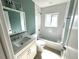 Clean bathroom with a white vanity, shower-tub combo, and mint accent wall at 814 19Th Sw St, Largo, FL 33770