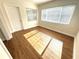 Sunlit bedroom with wood-look floors, blinds, and natural light at 814 19Th Sw St, Largo, FL 33770
