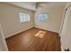Bright bedroom with wood-look flooring, natural light from two windows, and a ceiling fan at 814 19Th Sw St, Largo, FL 33770