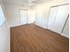 Bright bedroom featuring wood-look floors, a ceiling fan, and ample closet space at 814 19Th Sw St, Largo, FL 33770
