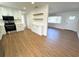 Open-concept kitchen features stainless steel appliances, white cabinets, and modern wood-look flooring at 814 19Th Sw St, Largo, FL 33770