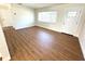 Bright living room featuring wood-look flooring, ample natural light, and a welcoming entrance at 814 19Th Sw St, Largo, FL 33770