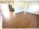 Open floor plan featuring a spacious living area with wood-look flooring leading to the modern kitchen at 814 19Th Sw St, Largo, FL 33770