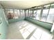 Enclosed sunroom featuring tiled floors, large windows, and a painted block wall at 814 19Th Sw St, Largo, FL 33770