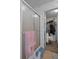 Bathroom featuring a glass shower door and walk-in closet with shelving at 8248 Irene St, Zephyrhills, FL 33540