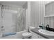 Clean bathroom featuring a shower-tub combo, toilet, and sink with storage at 8248 Irene St, Zephyrhills, FL 33540
