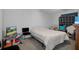 Simple bedroom featuring neutral walls, carpeted floor, basic furnishings including a bed and chair at 8248 Irene St, Zephyrhills, FL 33540