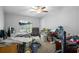 Simple bedroom featuring neutral walls, carpeted floor, basic furnishings including desk and chair at 8248 Irene St, Zephyrhills, FL 33540